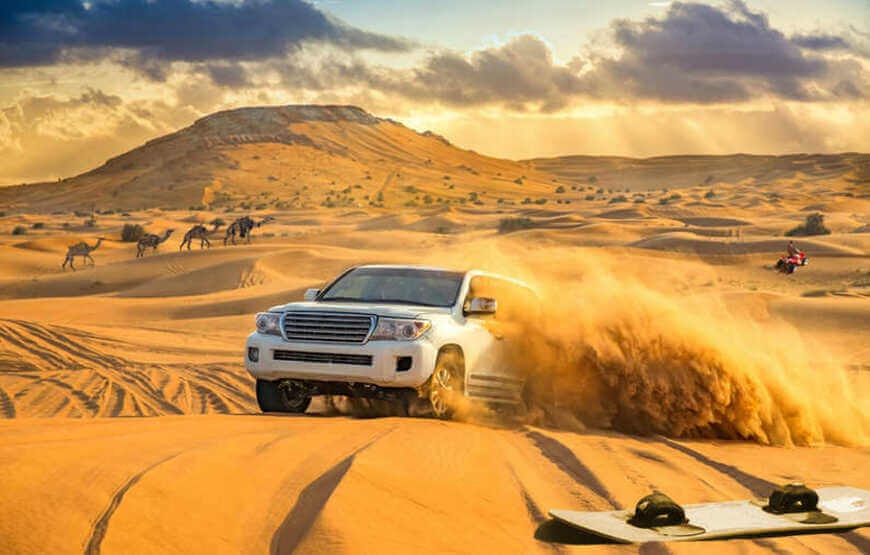 Morning Desert Safari Dubai with a 4x4 jeep driving on sand dunes against a backdrop of sunrise