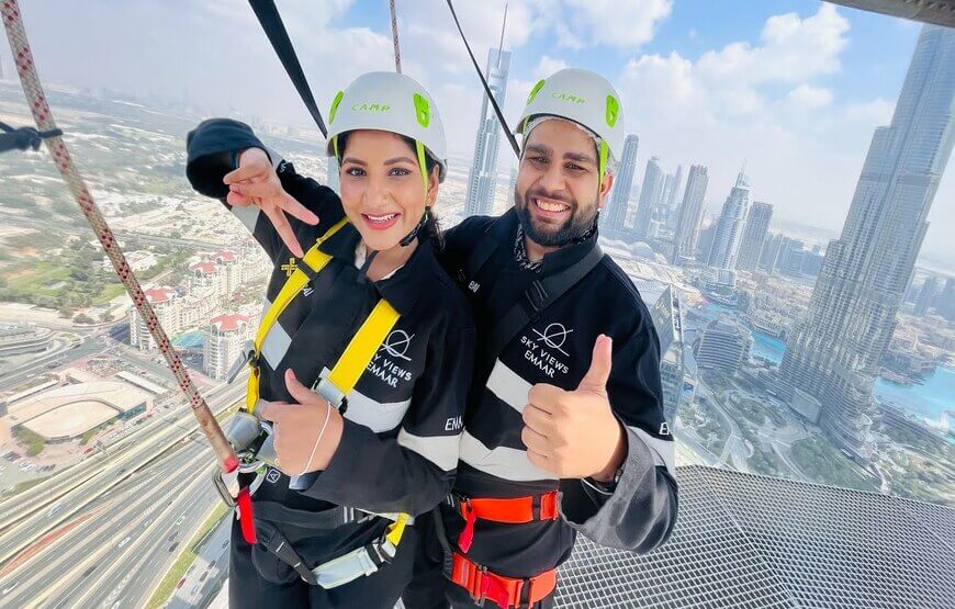 Sky Views Edge Walk Dubai at Address Sky View Observatory: Adrenaline-pumped walk outside with safety harness, 360-degree panoramic view of Dubai's skyline, glass bridge, patient instructor, Burj Khalifa, Dubai Frame, 52nd level, 22m above ground level.