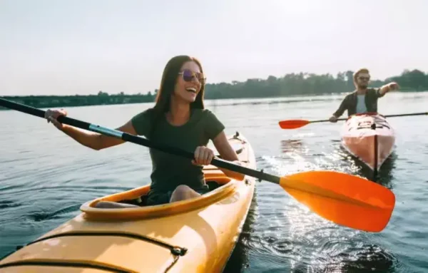 Kayak Single could be A person kayaking on calm waters with Dubai's iconic skyline in the background, surrounded by serene natural beauty