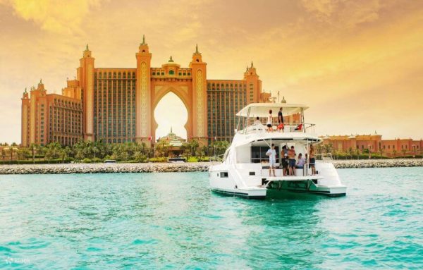 Yacht sailing through the calm waters with Dubai skyline in the background