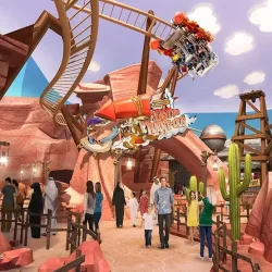 Visitors enjoying rides and attractions in the Cartoon Junction section of Warner Bros World Dubai, with colorful buildings and decorations in the background.