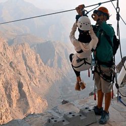 Jais Sky Tour could be People enjoying the world's longest zipline with scenic views of the Hajar Mountains in Jebel Jais, Dubai.