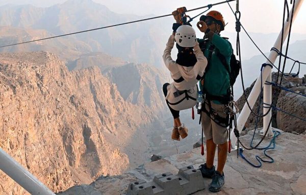 Jais Sky Tour could be People enjoying the world's longest zipline with scenic views of the Hajar Mountains in Jebel Jais, Dubai.